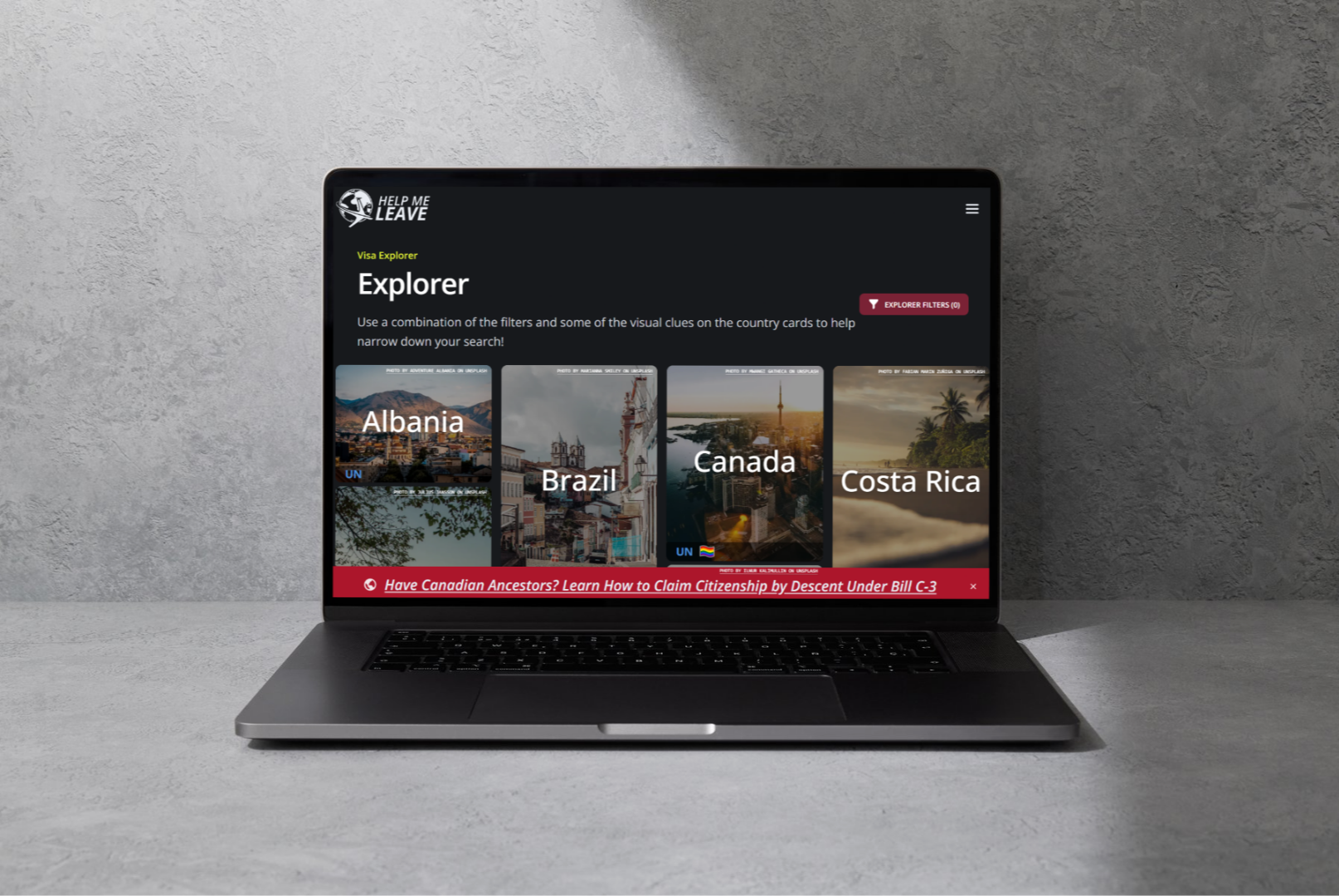 Laptop on a gray surface displaying a website titled 'Help Me Leave' with an exploration of country cards for Albania, Brazil, Canada, and Costa Rica.