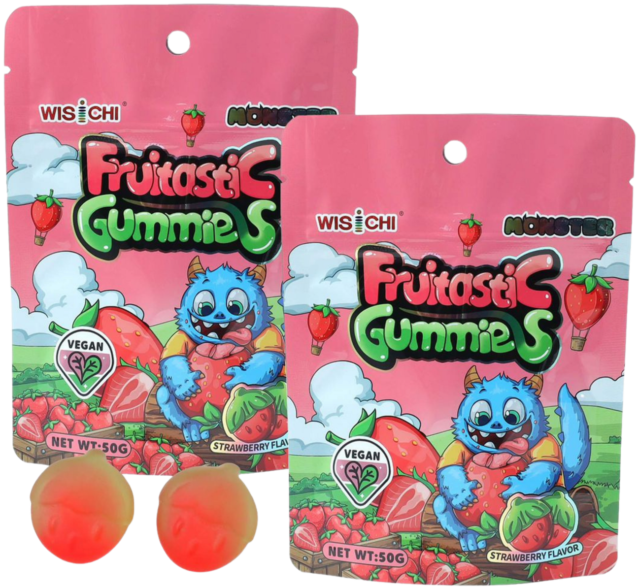 Two pink and green berry-flavored vegan gummy packages with cartoon monsters holding strawberries, and two round strawberry-colored gummies in the foreground.