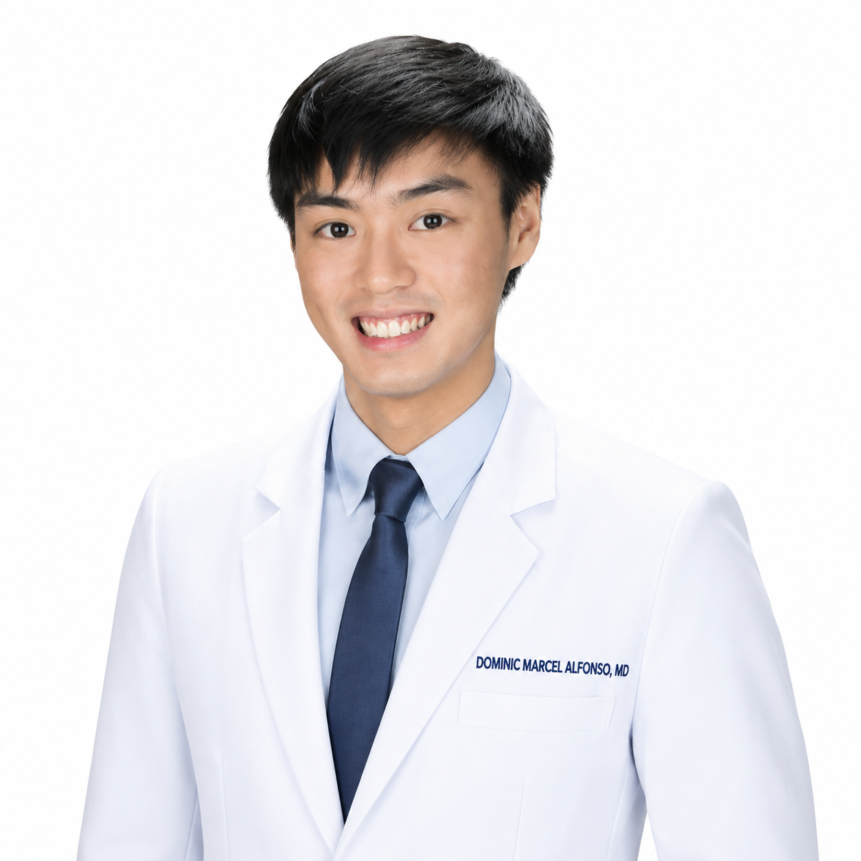 Smiling male doctor in white coat with name tag, against white background.