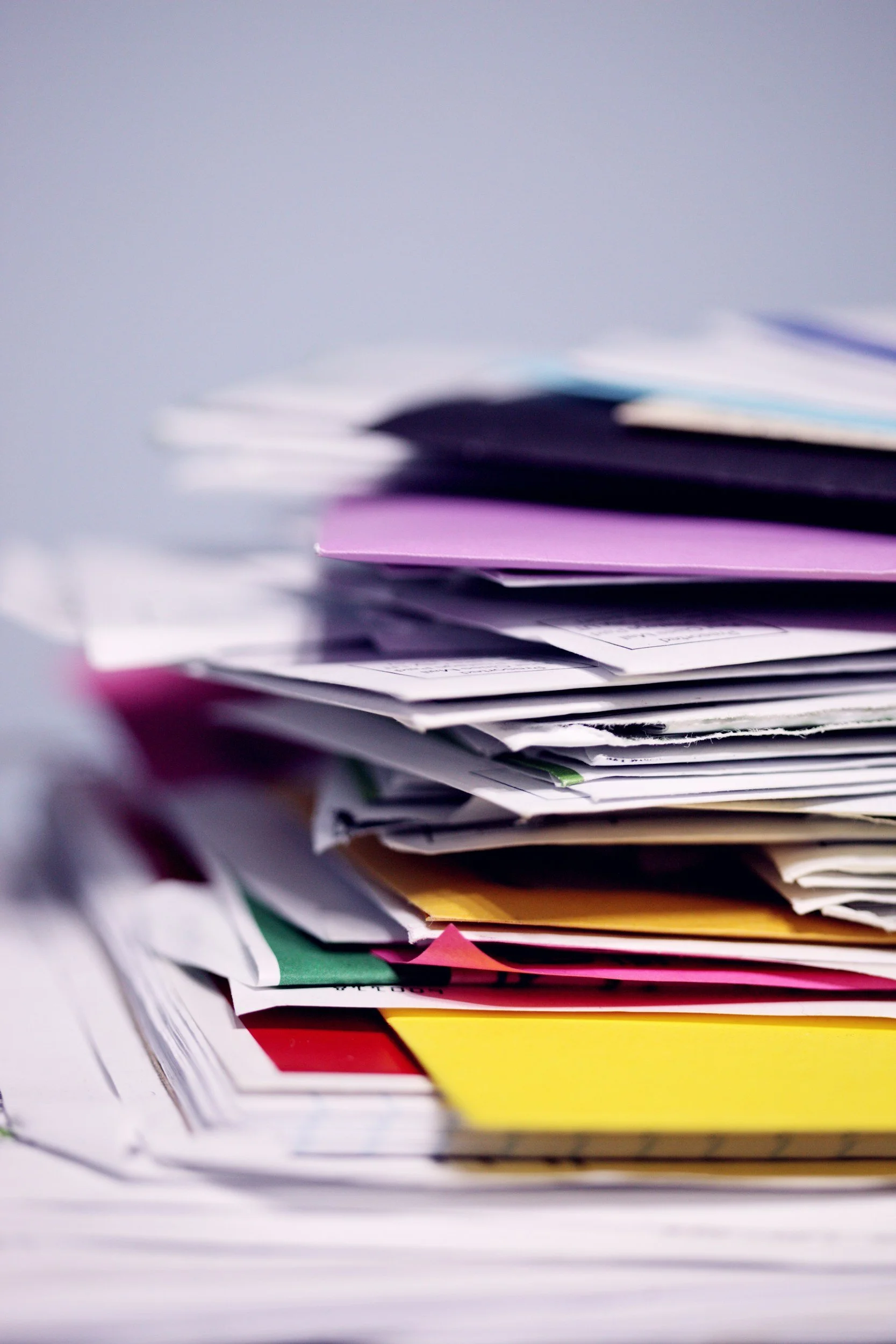 A picture of file folders in a messy pile.