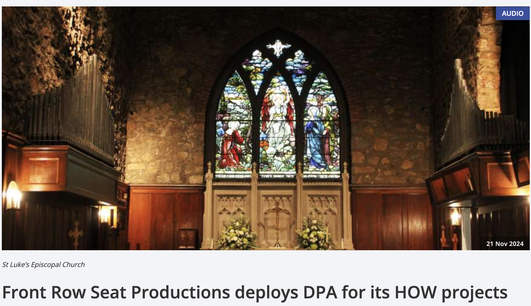 Interior of St Luke's Episcopal Church with a stained glass window depicting religious figures and a stone wall background.