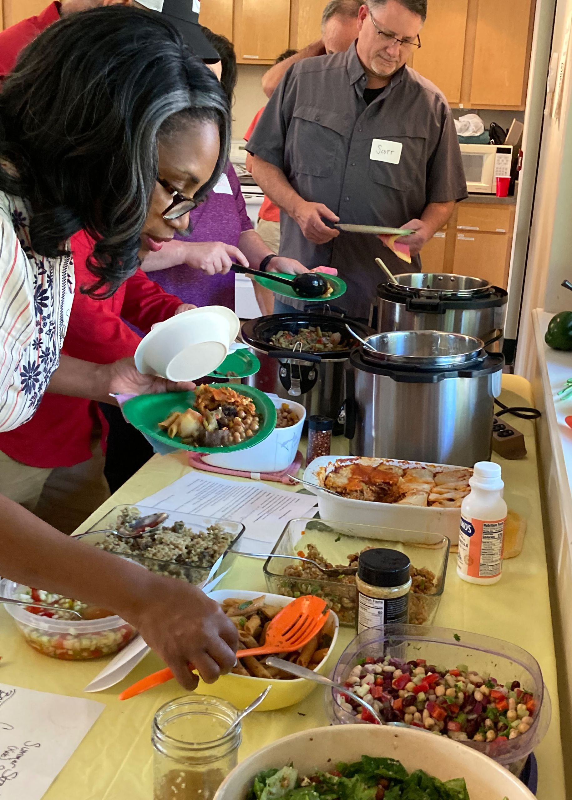 group enjoying potluck dinner