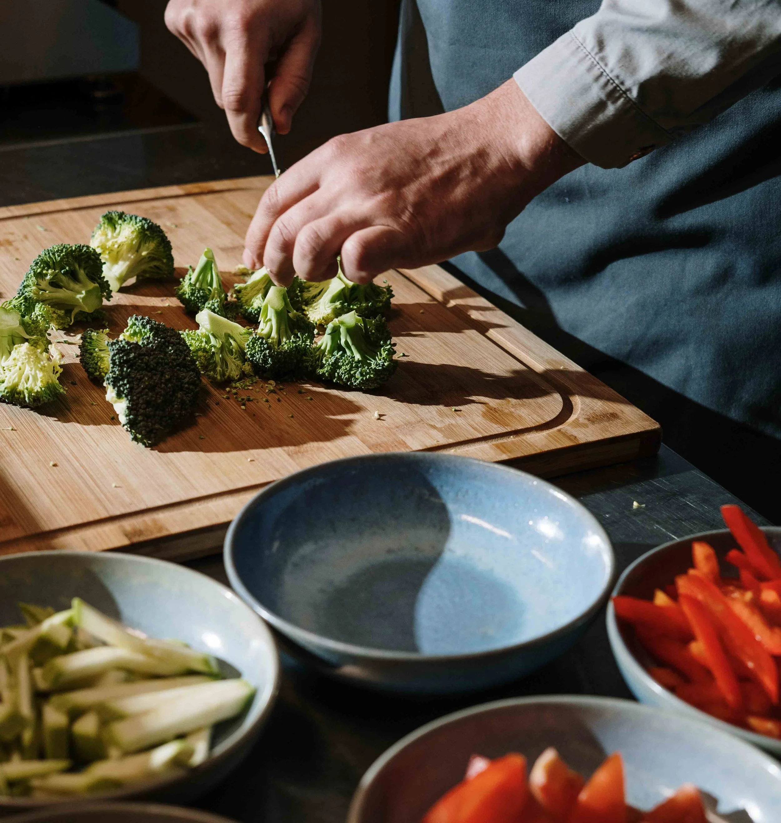 person cutting broccoli