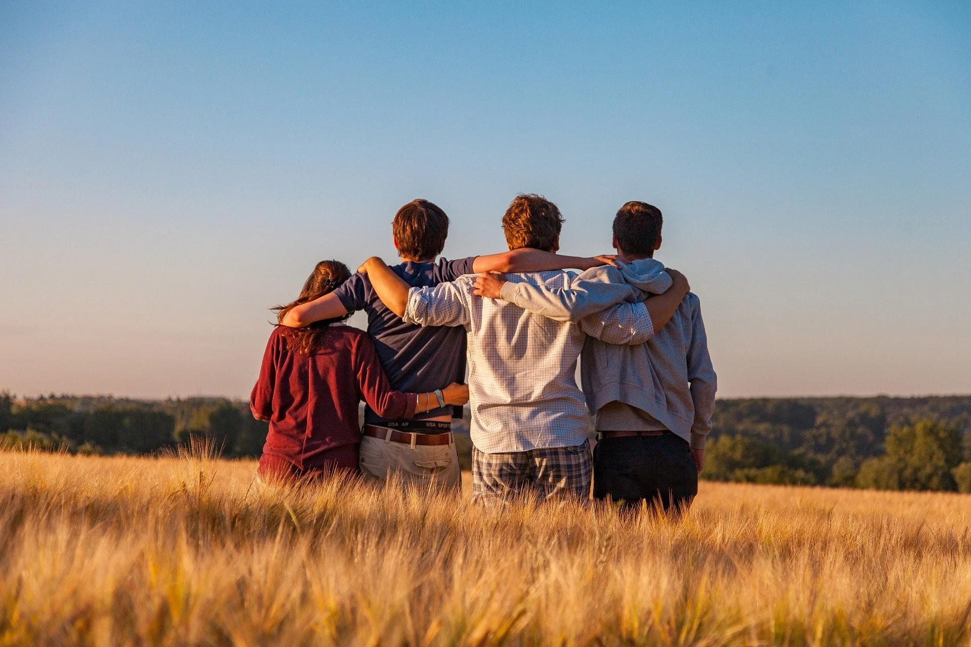 4 hikers, arm in arm