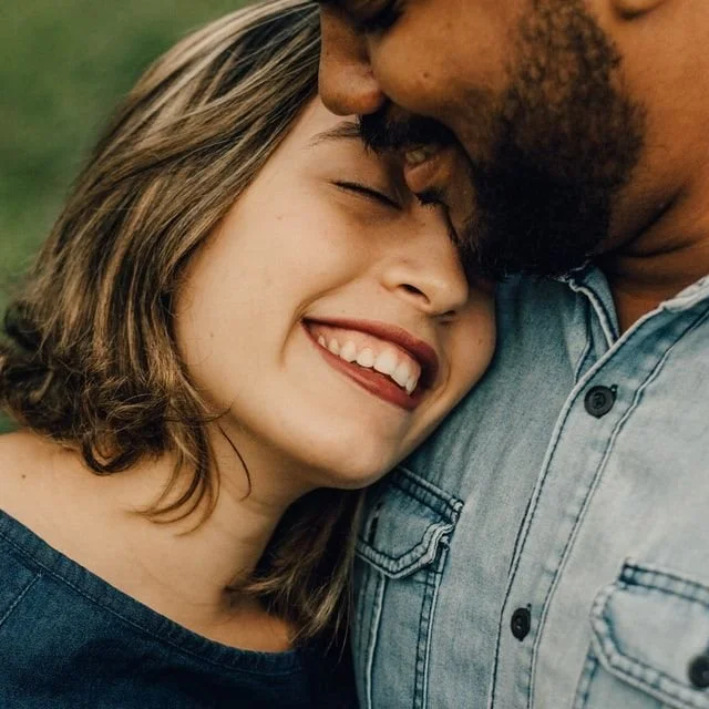 Woman snuggling with a man