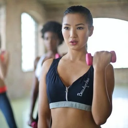 Woman with small hand weight at gym