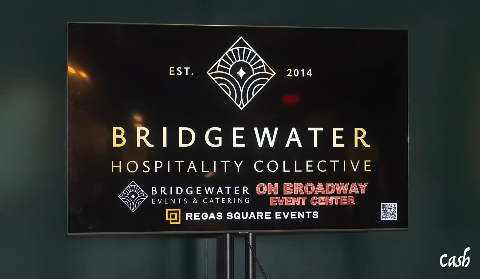 Digital sign advertising Bridgewater Hospitality Collective, established in 2014, hosting events at On Broadway Event Center and Regas Square Events, with a QR code and designer signature 'cash'.