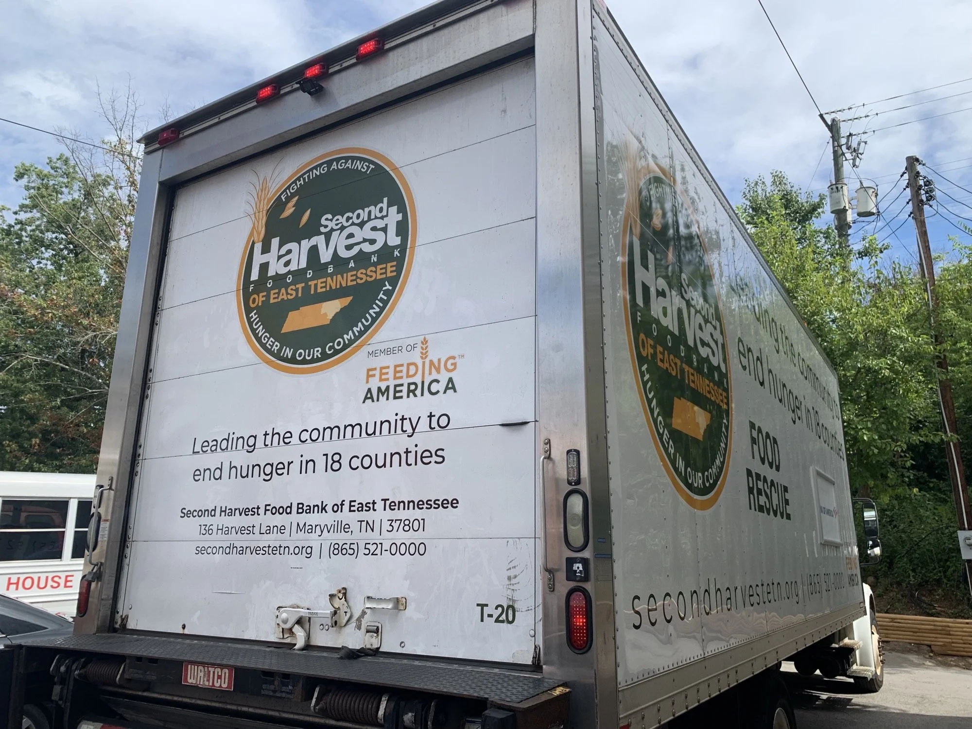 Food bank truck with Second Harvest logo, providing information about the organization and contact details in East Tennessee.