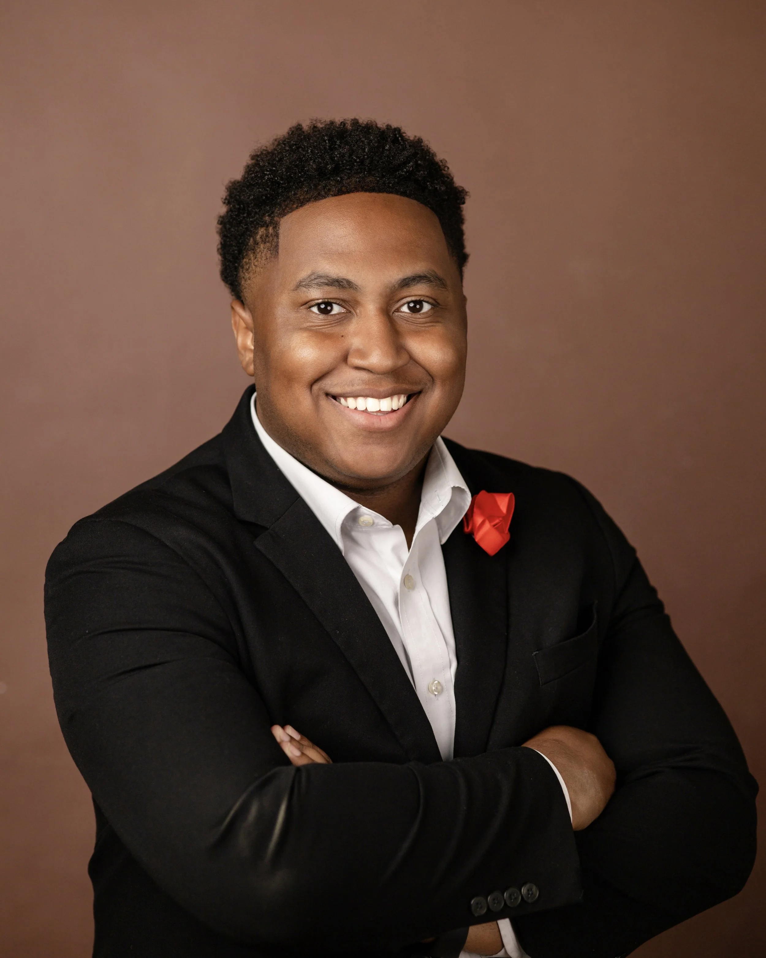 man smiling in black suit jacket