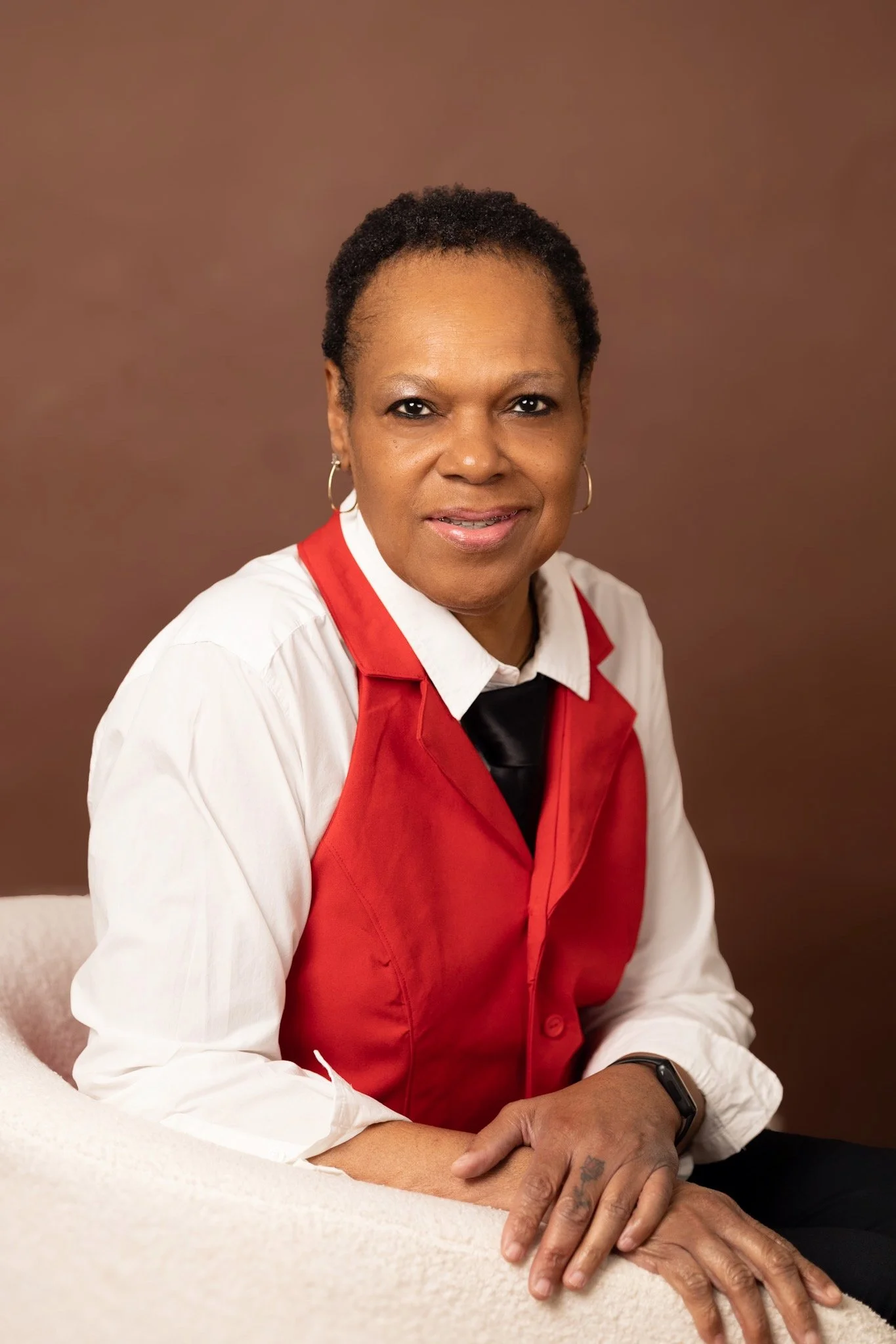 woman smiling in white and red shirt with a tie