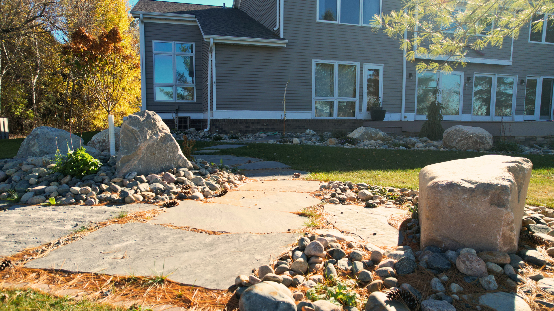 Sitting  Rock, rock bench, rock garden, flagstone pathway, lakeside access, large sitting rock, Island garden, landscape, touch of Eden Landscaping, landscaping, landscaper