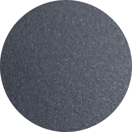 Close-up of a gray textured circular object, possibly a wheel or a disc.