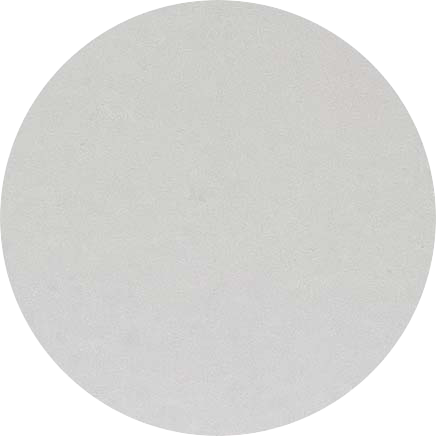 A plain, light-colored circular object, possibly a textured or matte paper surface.