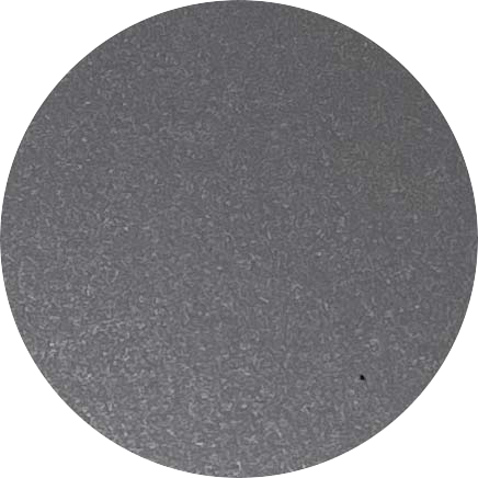 A circular close-up of a textured gray surface, possibly a stone or metal.