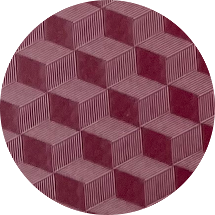 A close-up of a geometric pattern made of 3D cubes in shades of red and maroon, arranged in a honeycomb style.