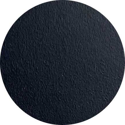 Close-up of a dark textured circular surface, possibly rubber or asphalt.