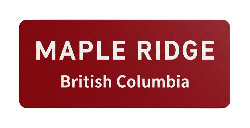 Red road sign with white text that reads "Maple Ridge British Columbia."