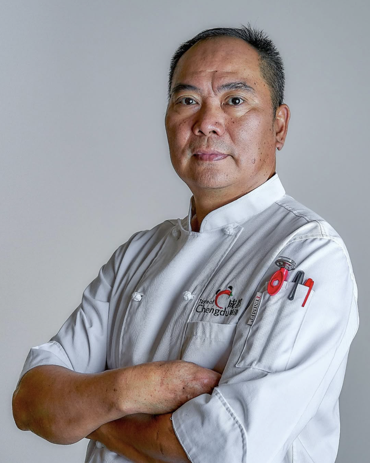 Chef Tiger wearing a white chef's coat at Taste of Chengdu in Orlando, FL