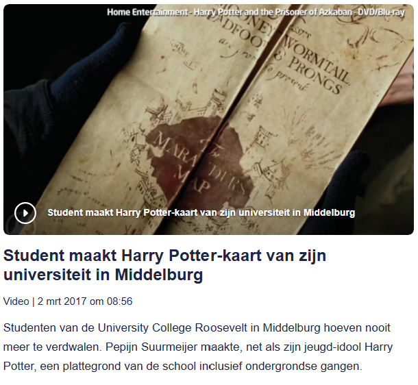 Student holding a Harry Potter-themed university card with an old parchment map design.