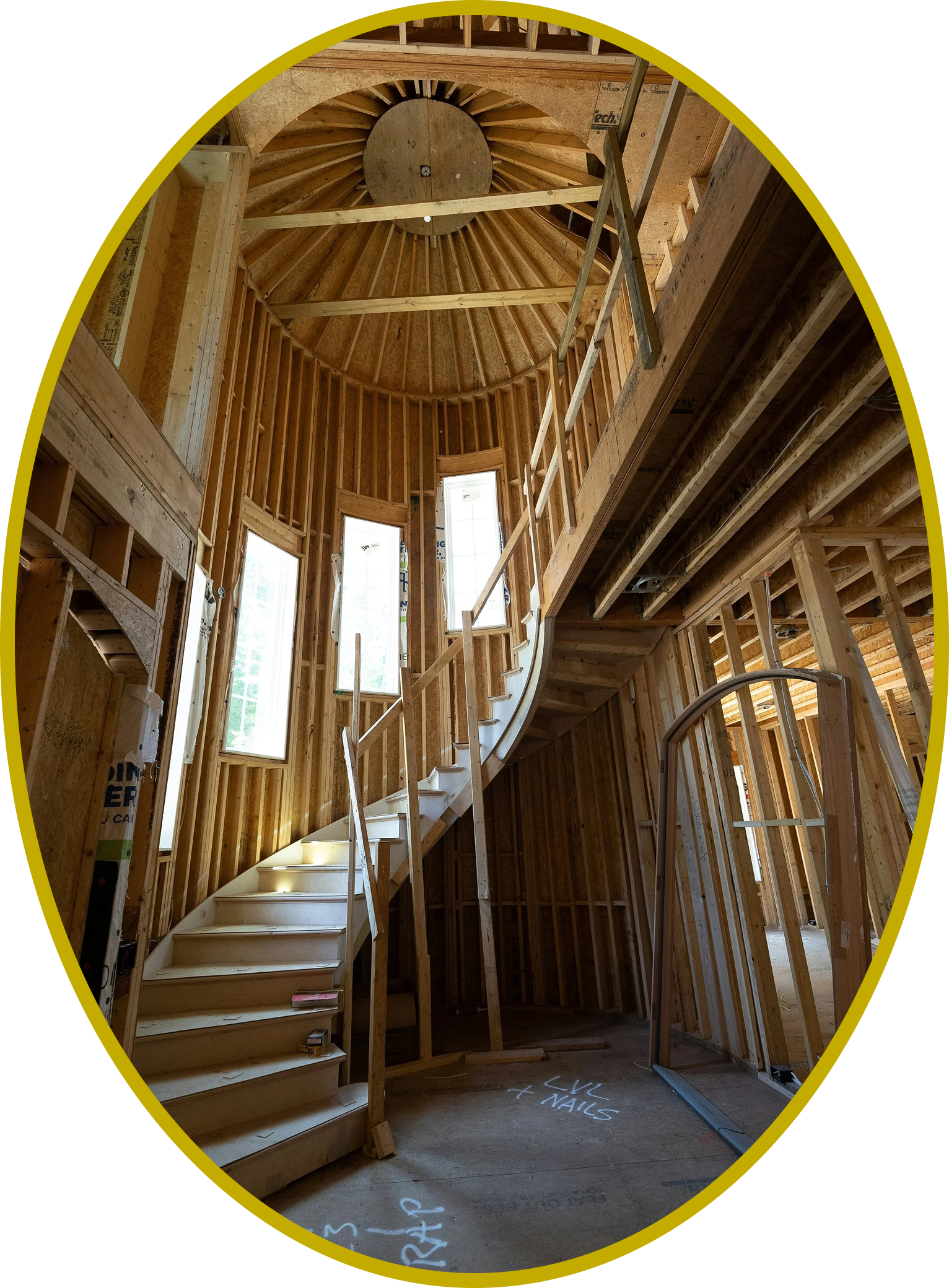 Custom home under construction showing dramatic curved spiral staircase and domed wood framing