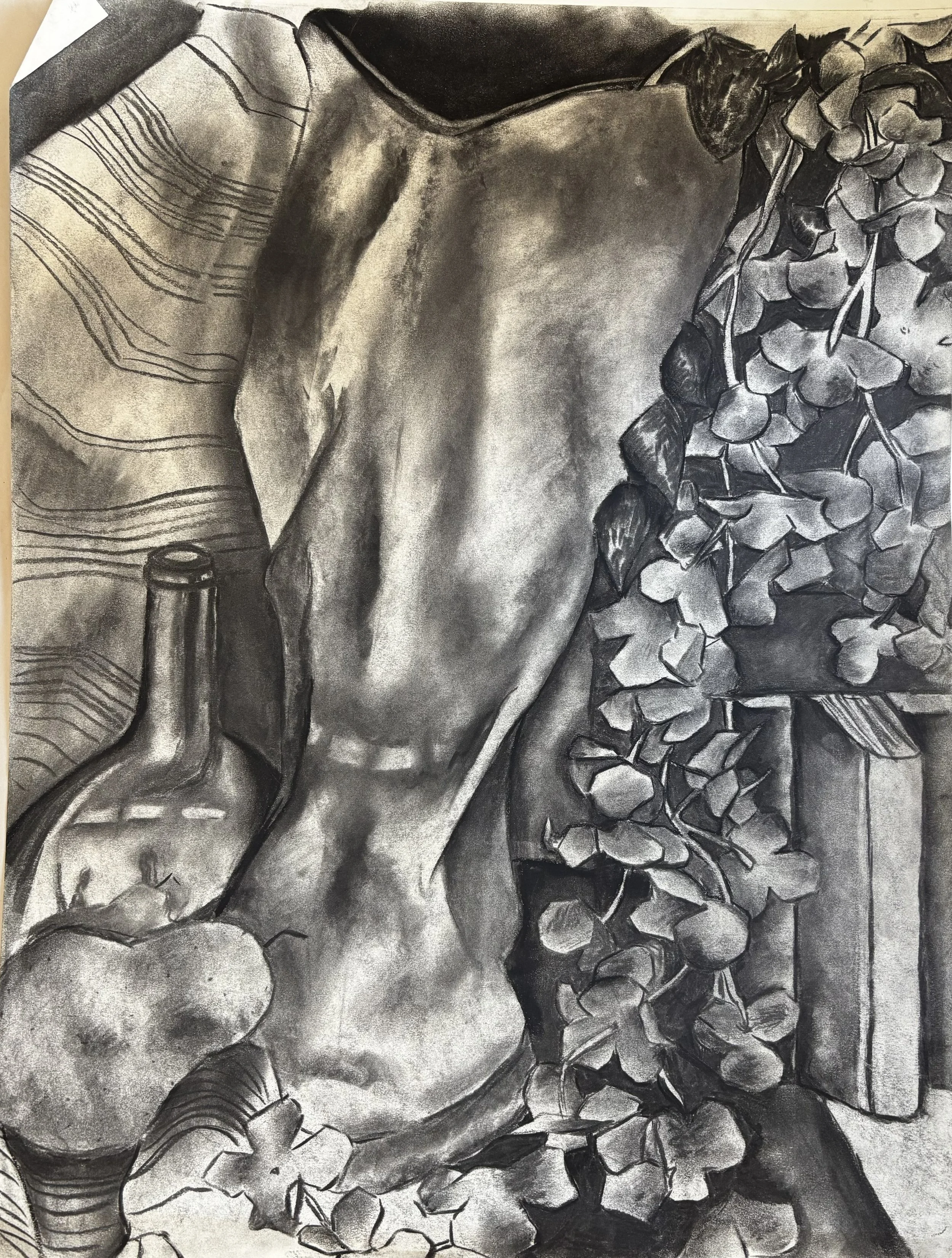 Charcoal drawing of a vine of flowers, with a cloth and a bottle in the background.