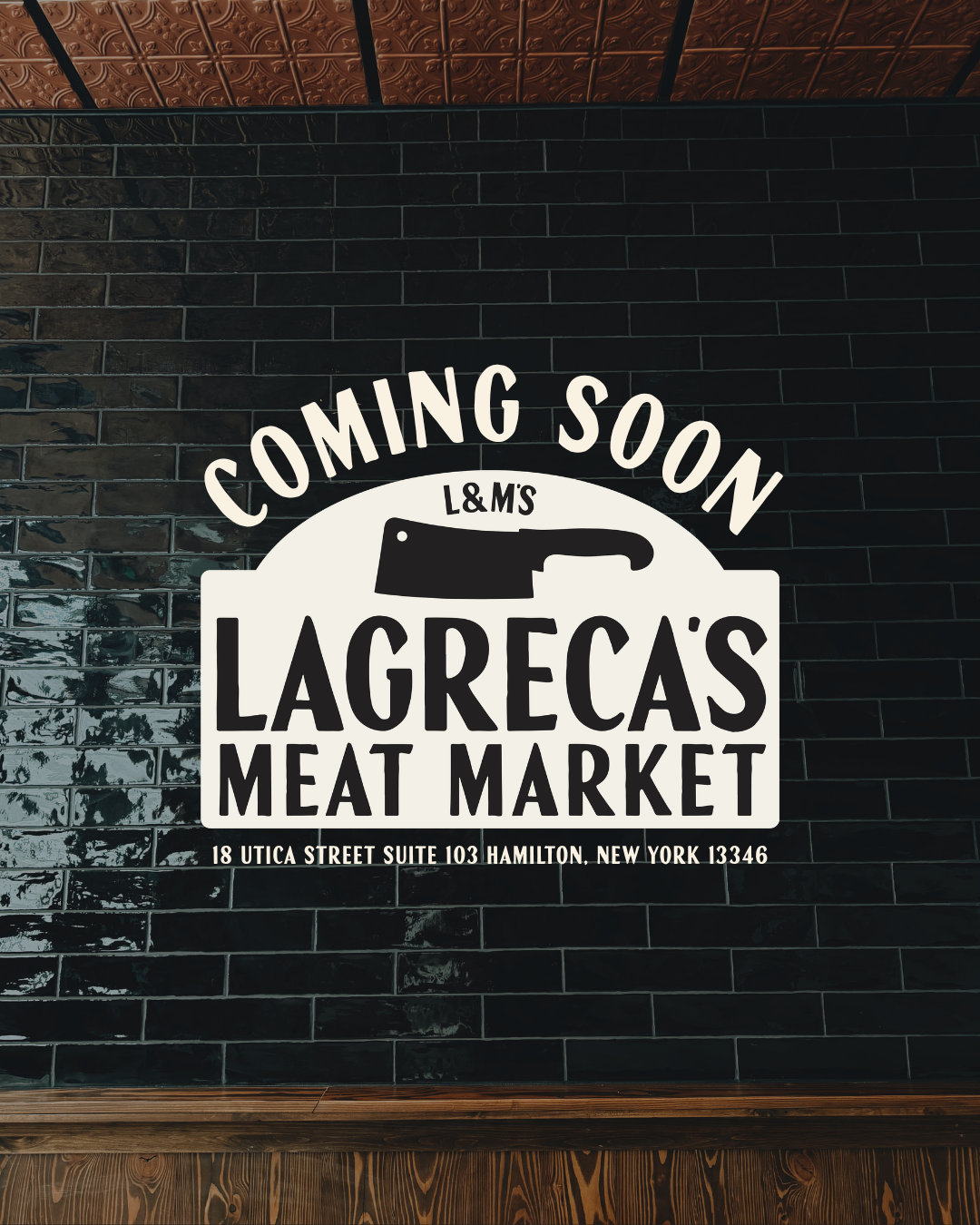 Sign for LaGreca's Meat Market with a butcher knife graphic and text indicating it is coming soon, located at 18 Utica Street, Suite 103, Hamilton, New York.
