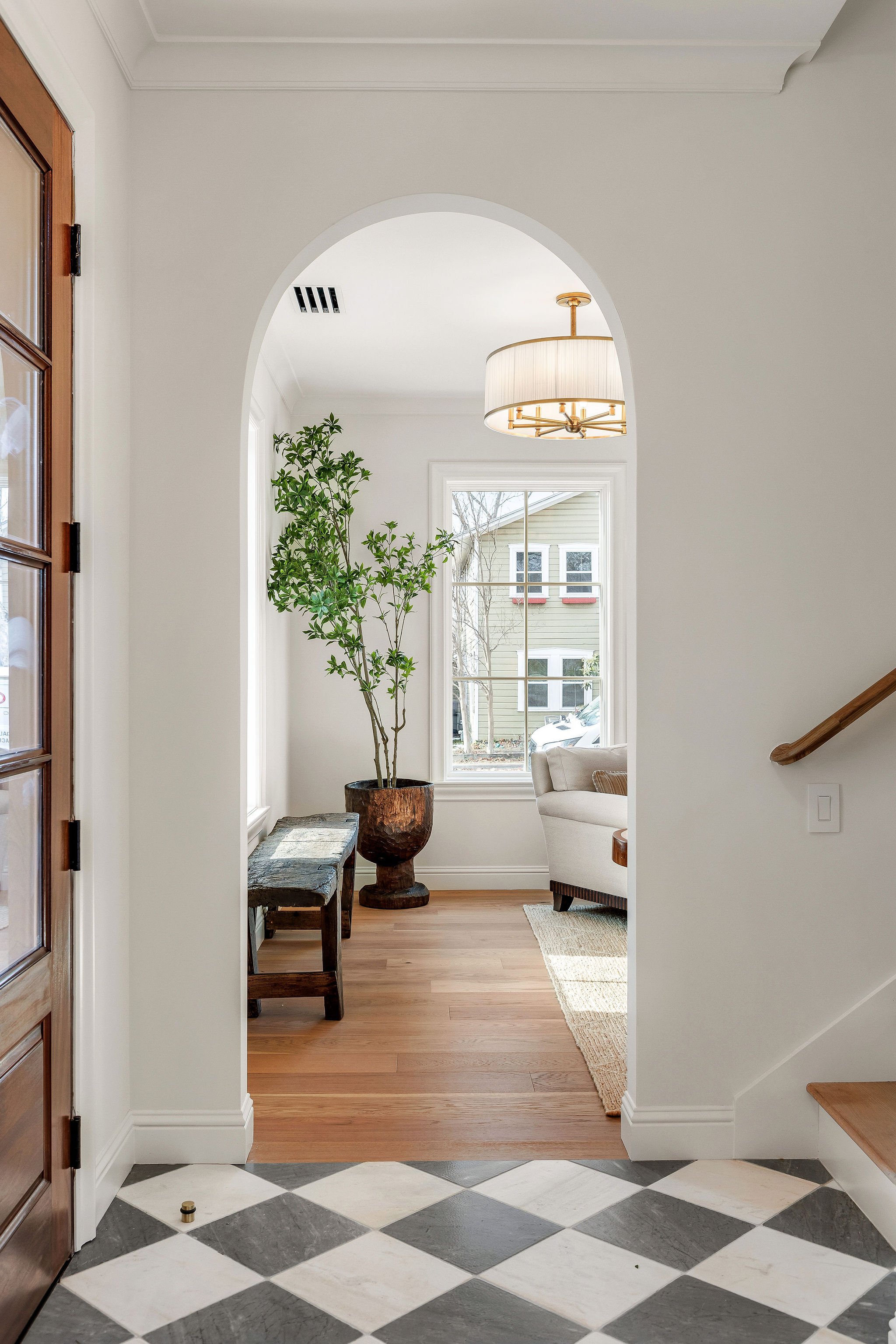 4909 Ave G: Architecturally refined interior of a custom Hyde Park residence featuring a statement limestone fireplace, imported Italian lighting, and a show-stopping kitchen with a Bianco Carrara marble island, custom oak cabinetry, and a Dacor indu