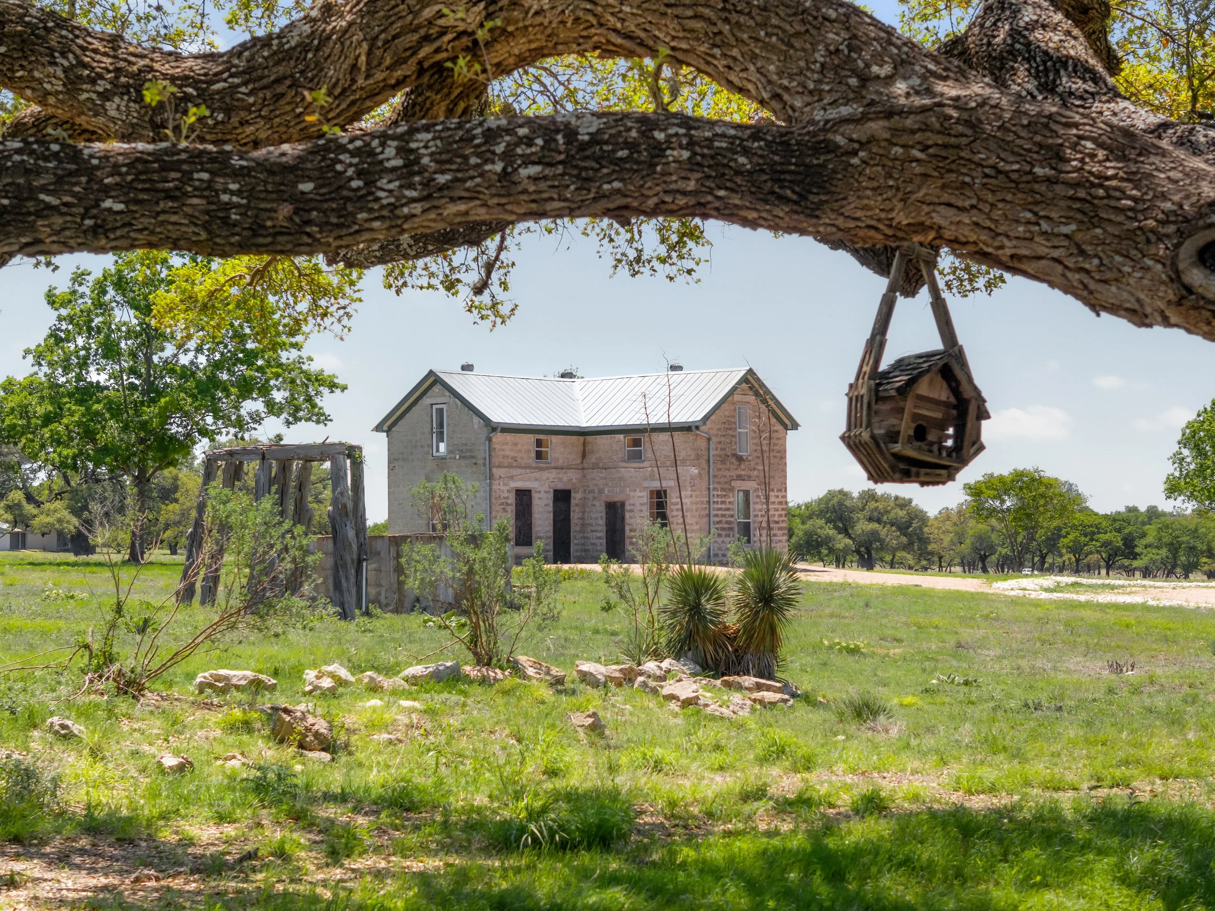 Sweeping aerial view of Hye Farms, an exceptional 54-acre Hill Country property along the renowned 290 Wine Trail, showcasing rolling terrain, open pastureland, and the boundless natural beauty of the Texas Hill Country landscape.