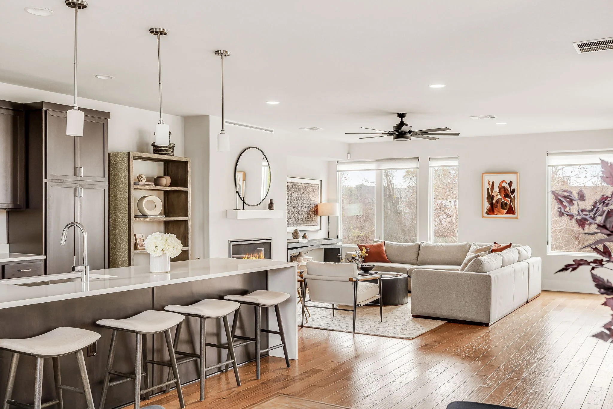 7921 Floracita #26: Light-filled contemporary interior of a refined Cayena residence in Southwest Austin, featuring clean architectural lines, warm hardwood floors, and an elevated open-concept layout that flows seamlessly between living and dining s