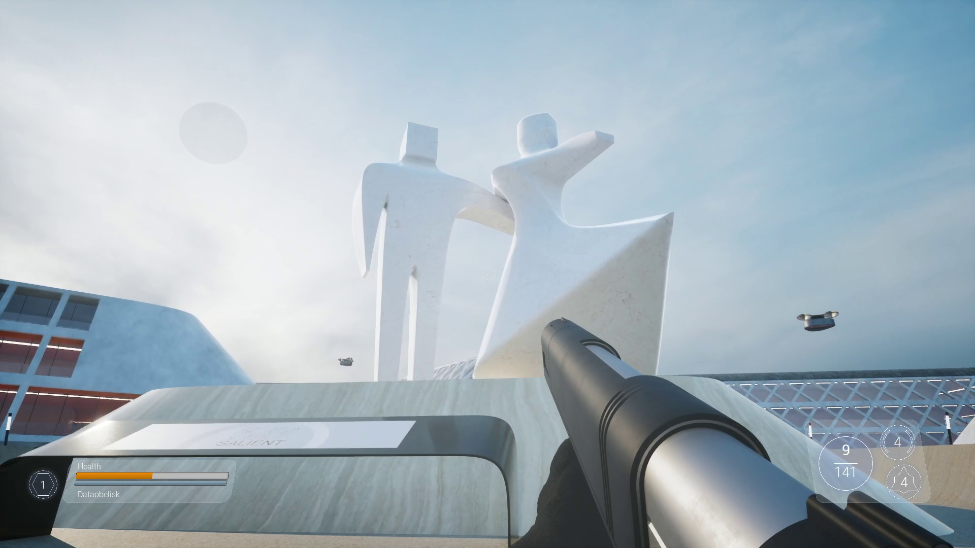 From the video game Verum Titan showing a white abstract sculpture of two human figures, set against a cloudy sky with a building and drones in the background.