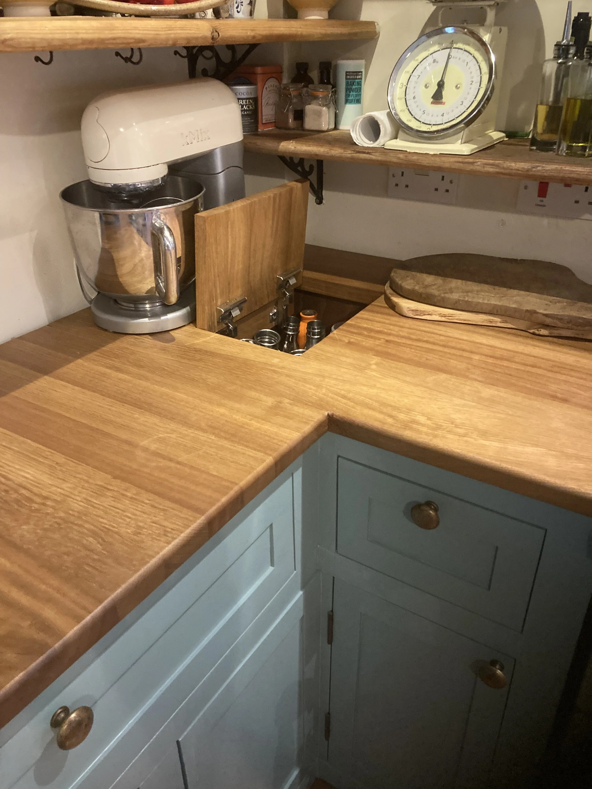 Kitchen corner unit with iroko top and hidden bottle storage