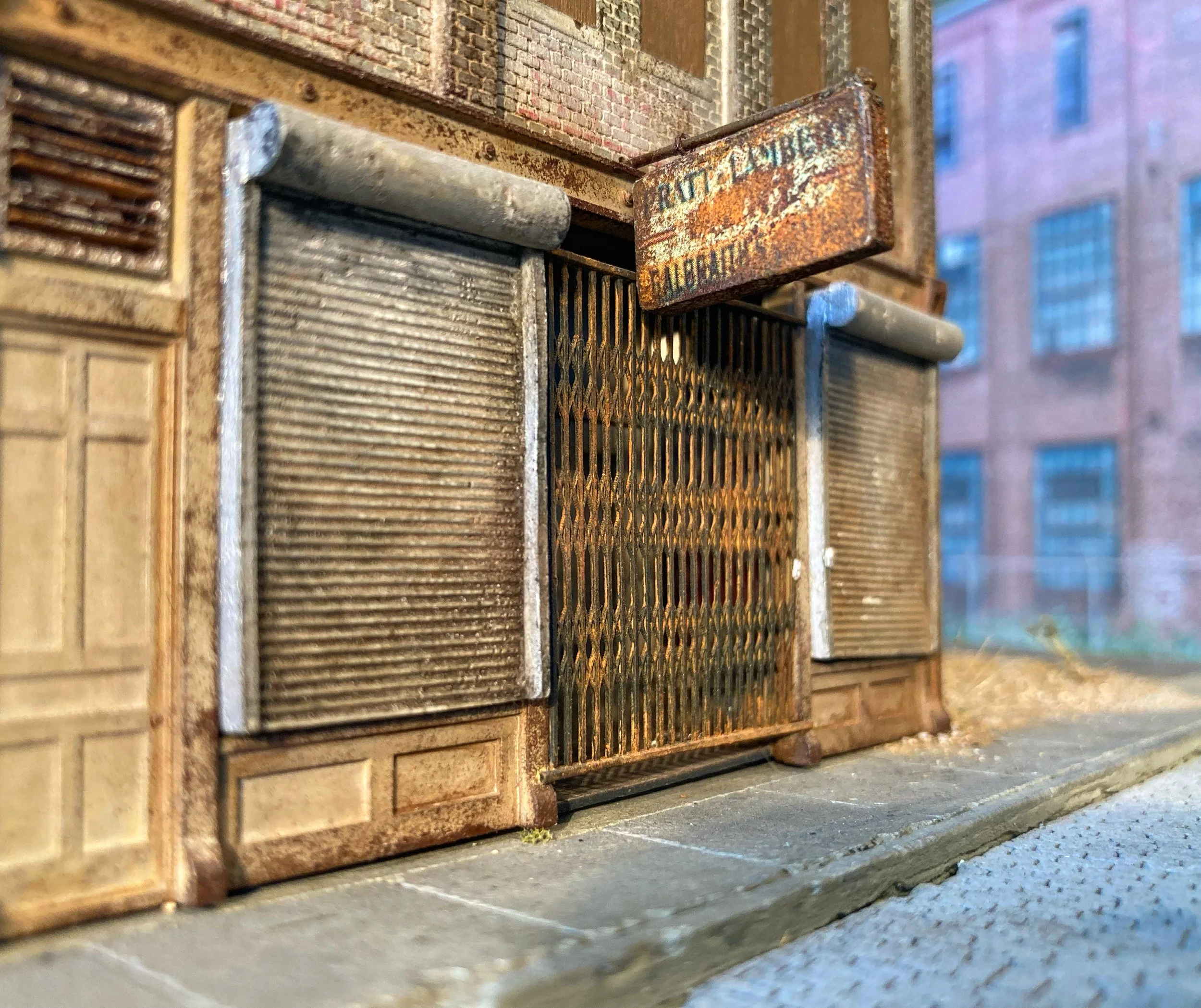 Close-up of fire escape stairs with rusted metal surface and a brick building in the background.