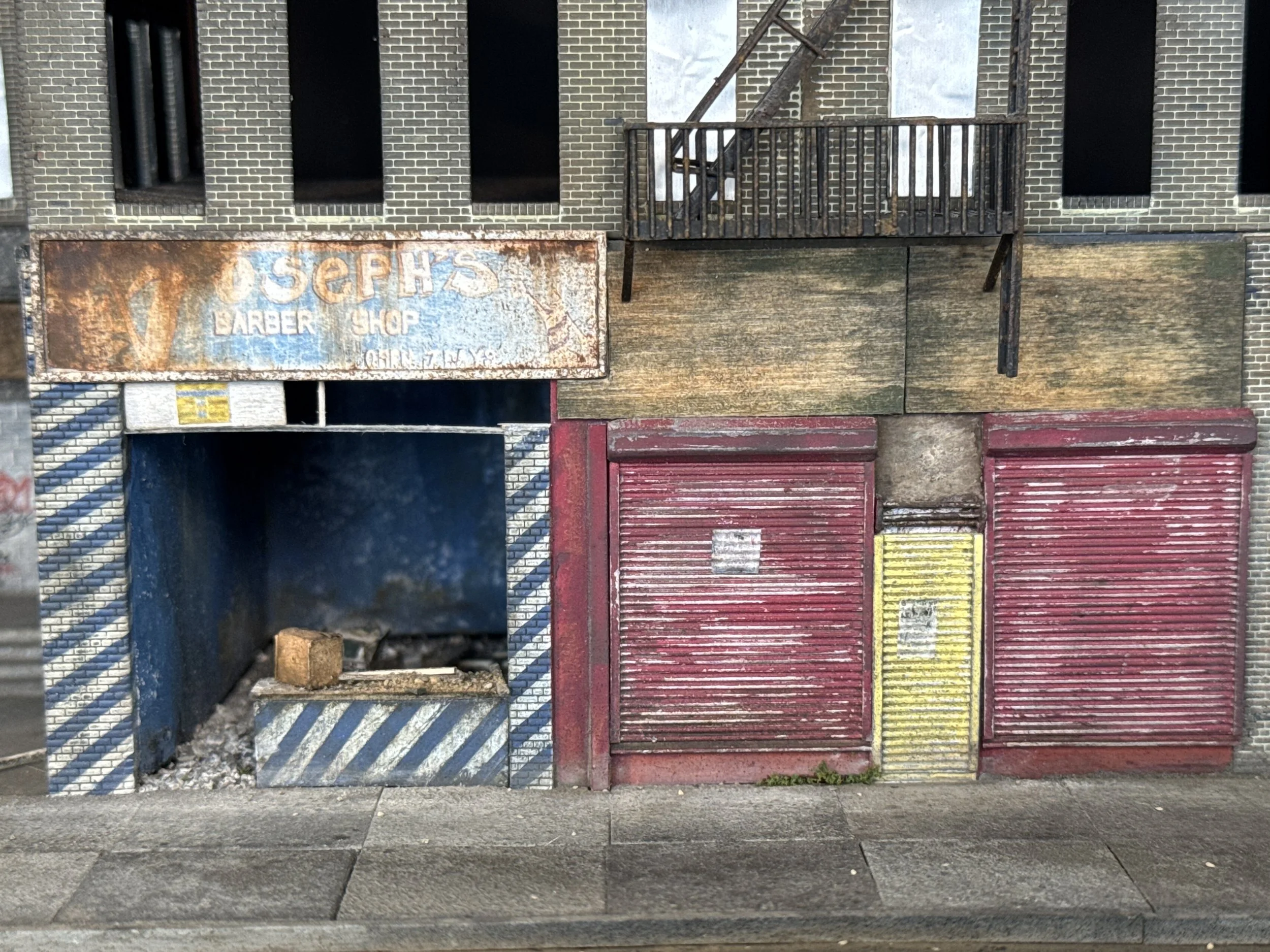 A collage of various old and weathered storefronts and doors, including a rusty sign for a barber shop and colorful metal shutters.