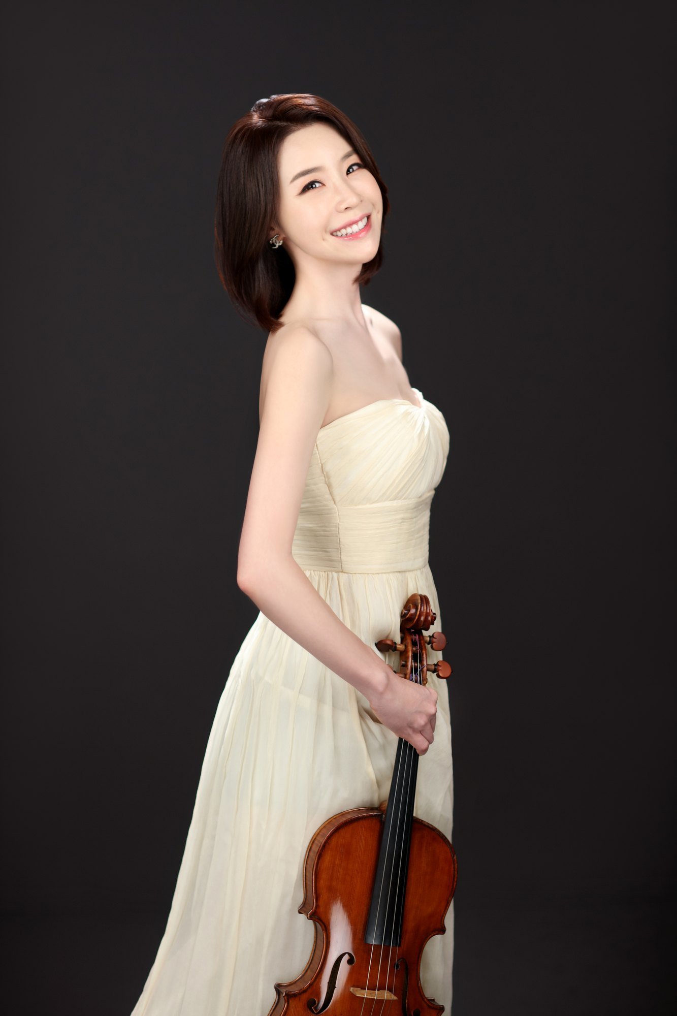 Amy Dahm Huh in an ivory gown with her viola
