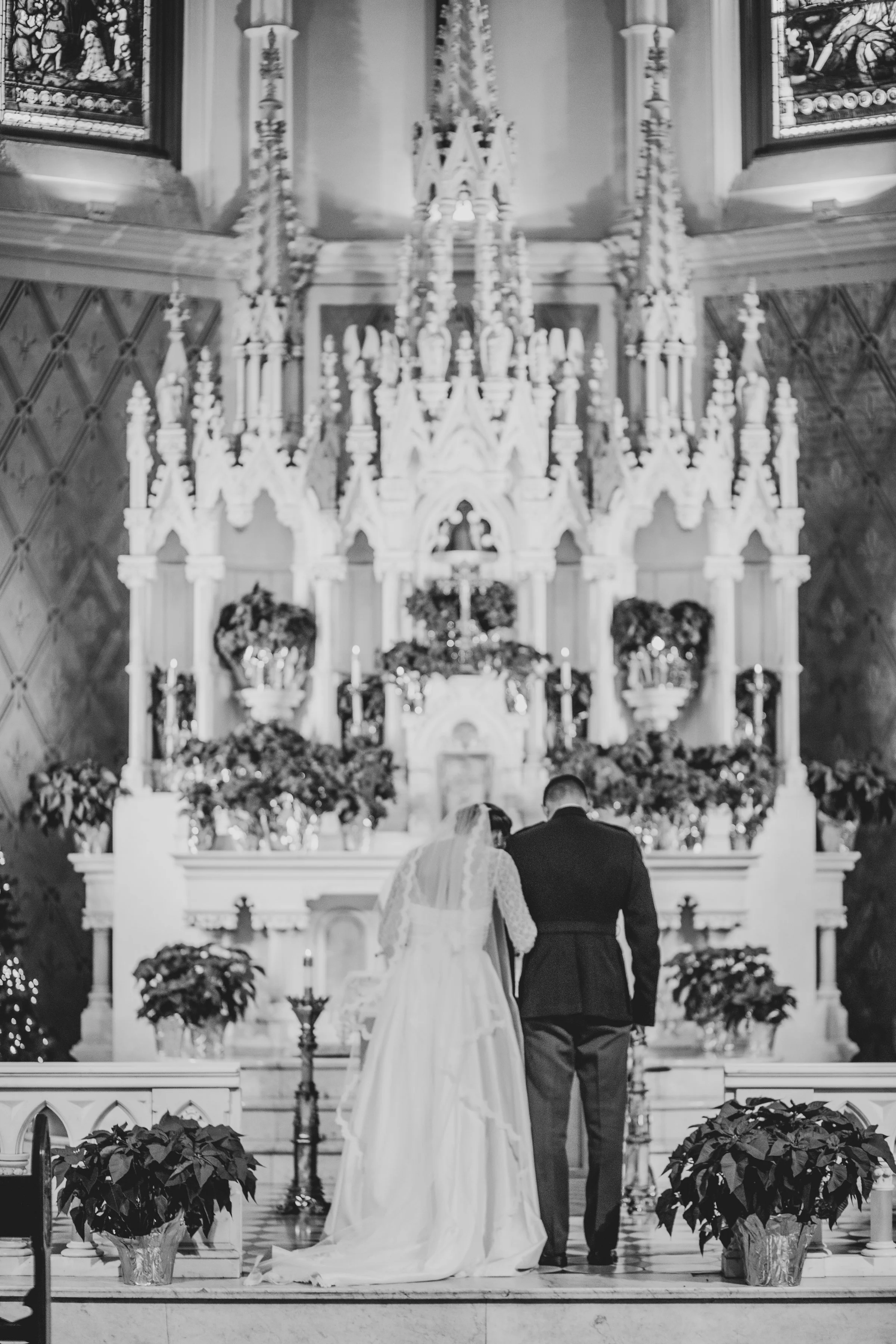 A bride and groom standing at the altar during a wedding ceremony inside a church.