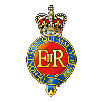The Household Cavalry Badge featuring a Royal emblem featuring a crown atop a circular badge with the words 'Honi Soit Qui Mal Y Pense' and 'FIR' in the center, set against a black background.