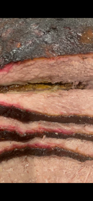 Close-up view of sliced cooked meat, showing different layers and textures.