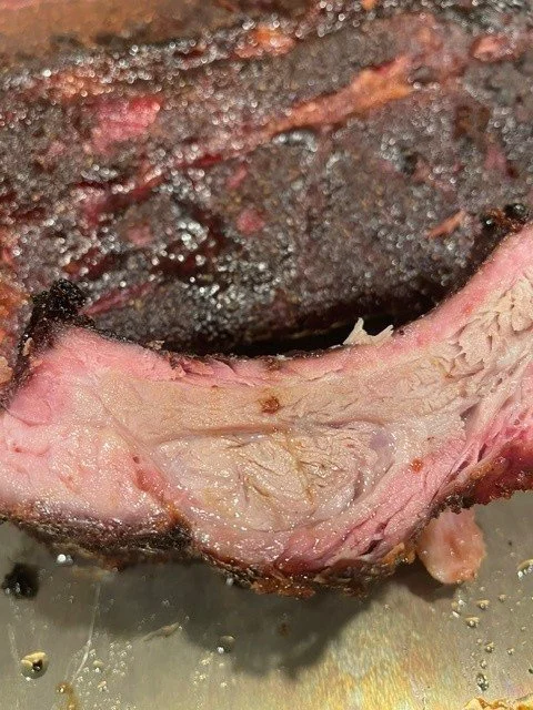Close-up of a piece of cooked meat showing pink, moist interior.