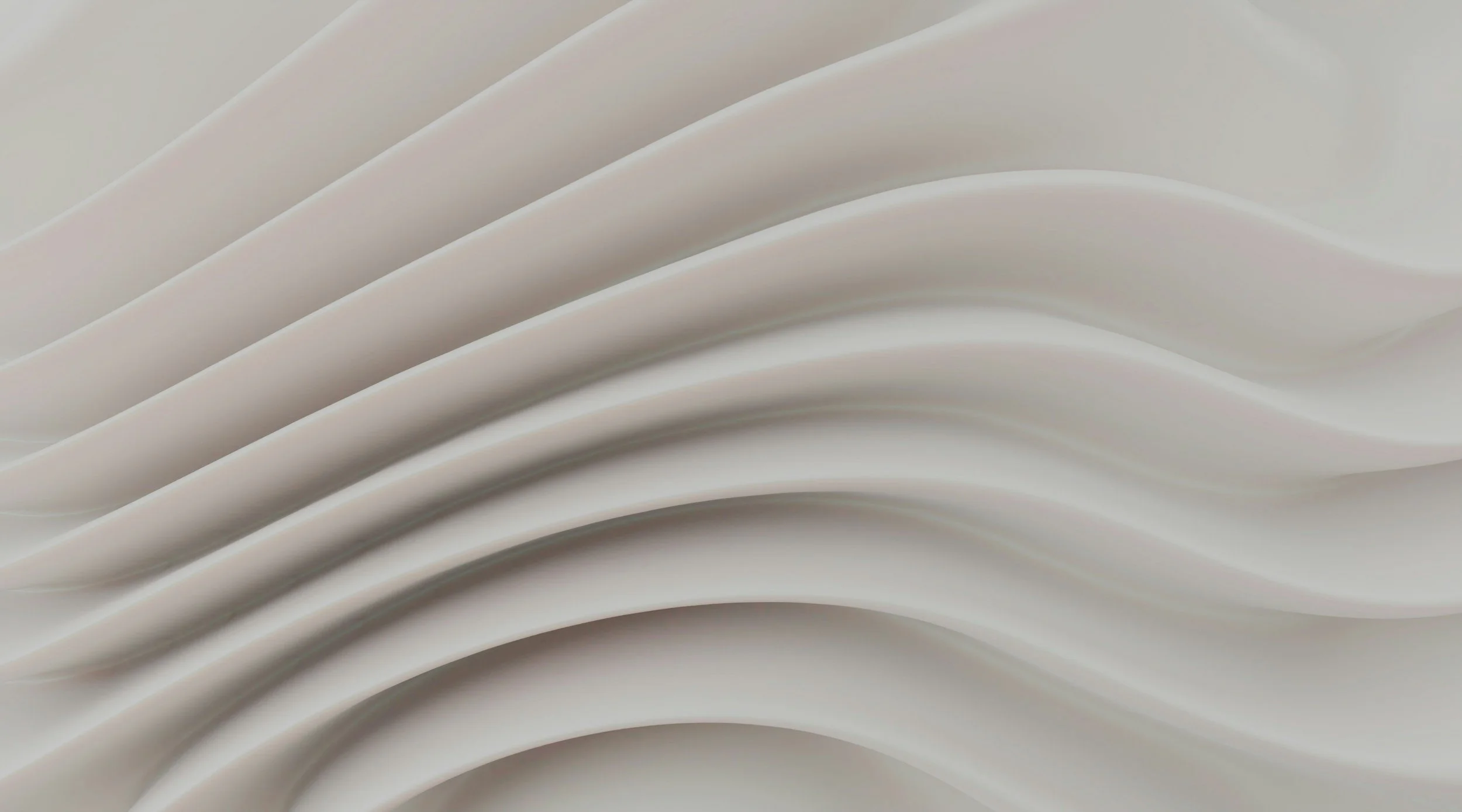 Close-up of white, curved architectural or decorative panels with smooth, flowing lines.