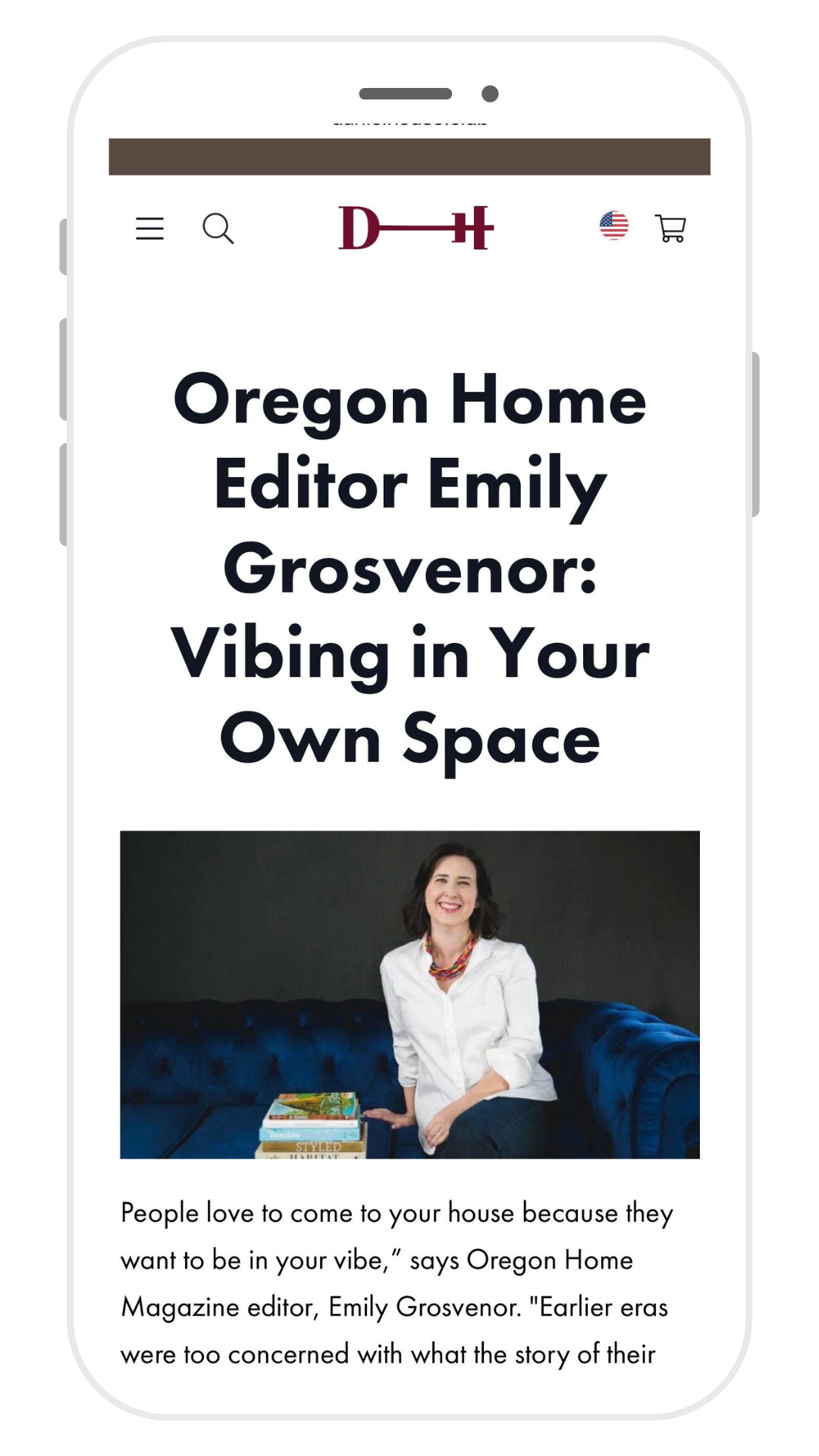 A mobile webpage with the title "Oregon Home Editor Emily Grosvenor: Vibing in Your Own Space" and a photo of a smiling woman sitting on a blue sofa with a stack of books in front of her.