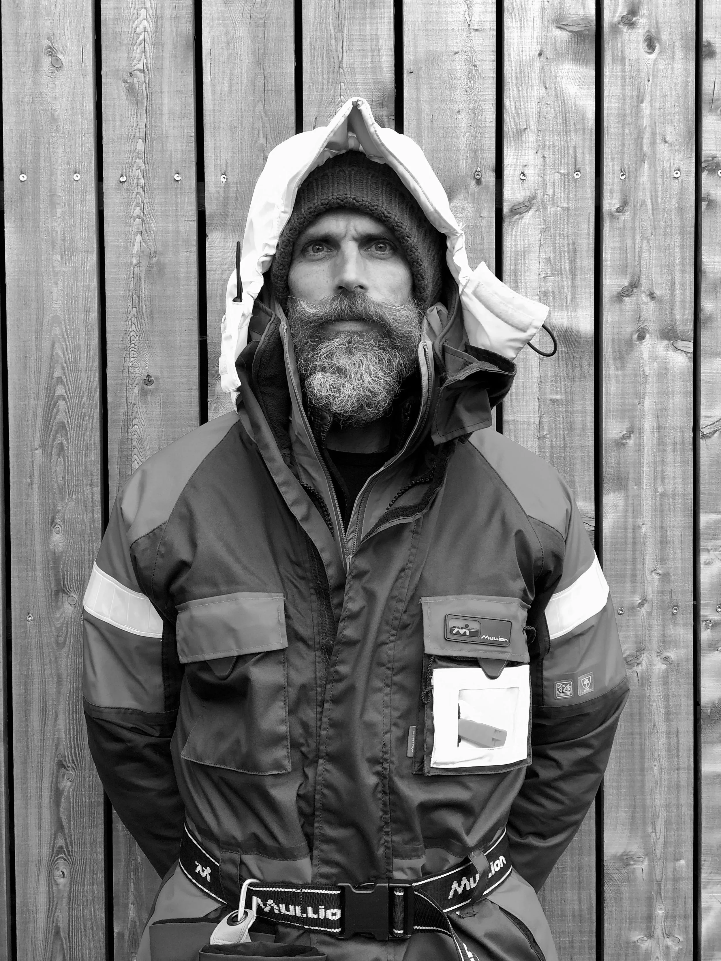 Eric Druckenmiller, independent strategist. Black-and-white portrait, face partially obscured by a hooded jacket.