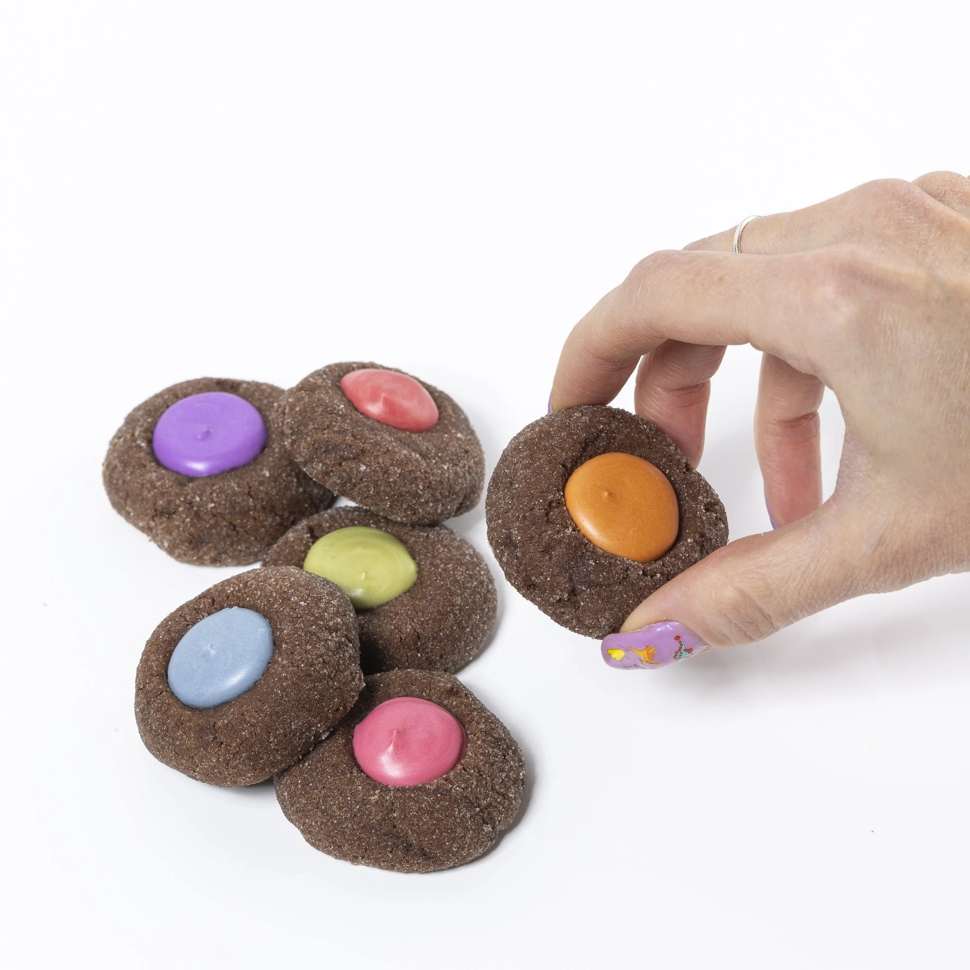 Chocolate Thumbprint Cookies - 

These thumbprints are a rich chocolate cookie, with the same vanilla icing center as our traditional thumbprint. The cookies are rolled in sugar for added texture, and that chocolate is complemented by just a hint of 