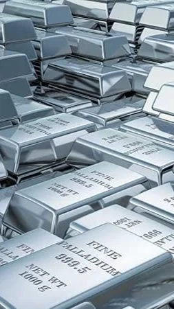 A large pile of silver bars, possibly silver bullion, stacked haphazardly.