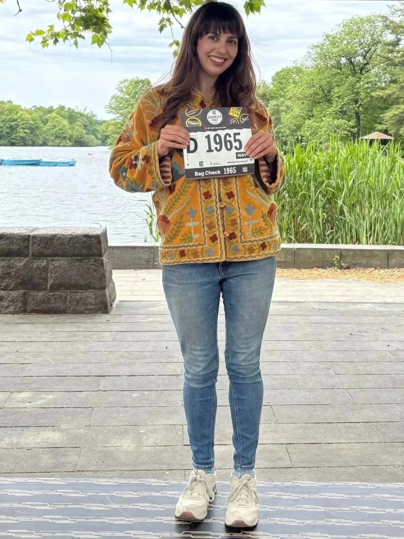 female run coach holding race bib
