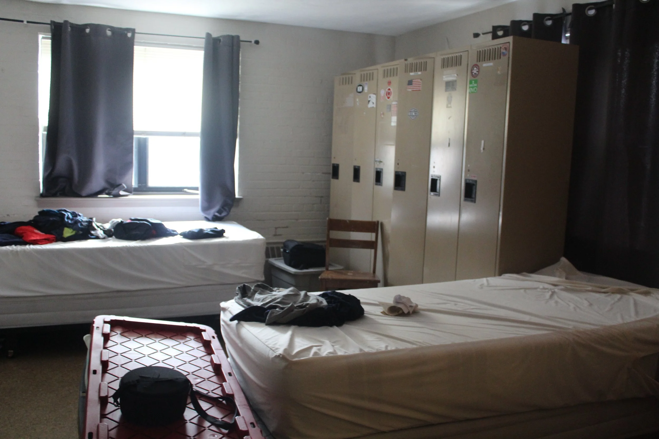 A look of at one of the dorm rooms in Fire Station 1 with multiple beds and lockers