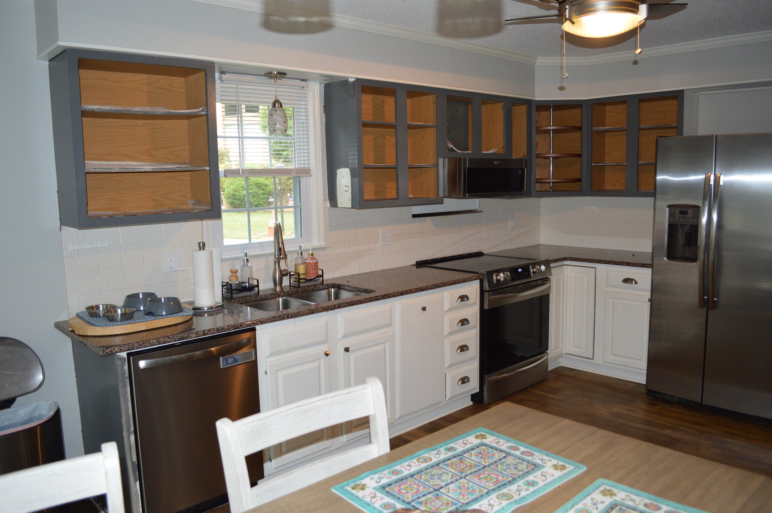 before picture with old cabinets, popcorn ceilings, no counter space