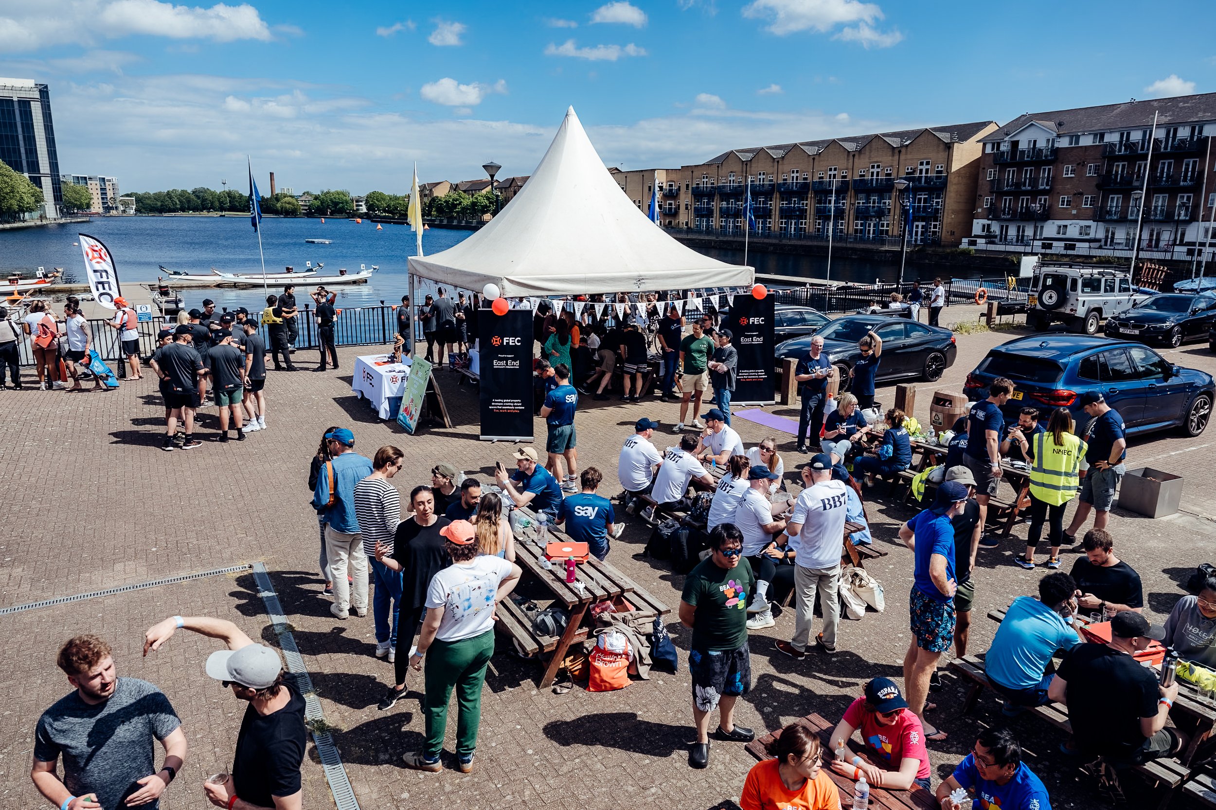 Corporate team building at the Far East Consortium (FEC) Charity Dragon Boat Festival, supporting the East End Community Foundation in London. Professional event photography by Will Bailey.