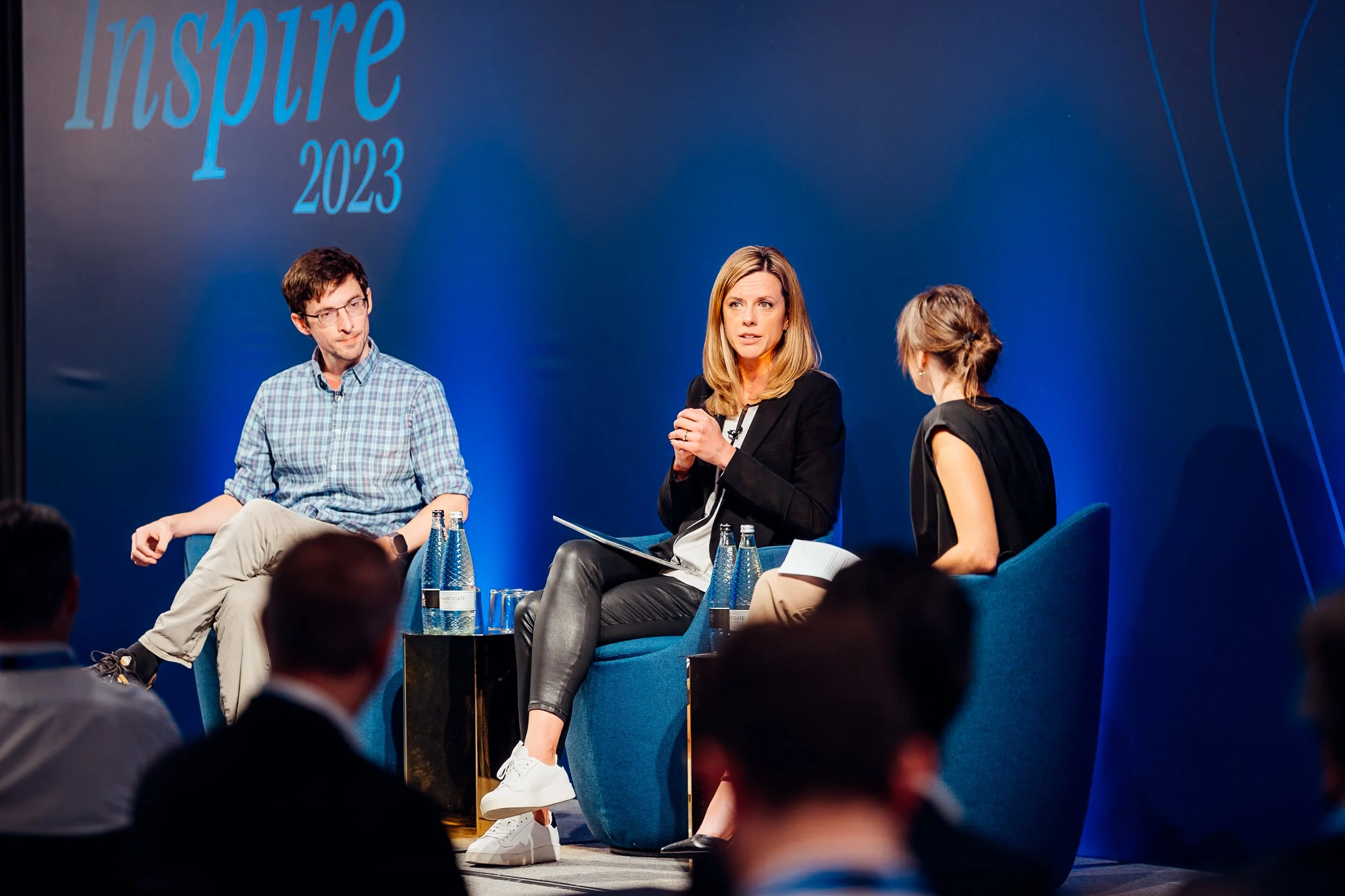 A corporate panel discussion group taking questions on stage at the NetDocuments Inspire conference, hosted at Convene 22 Bishopsgate, London. B2B summit and panel debate photography by Will Bailey.