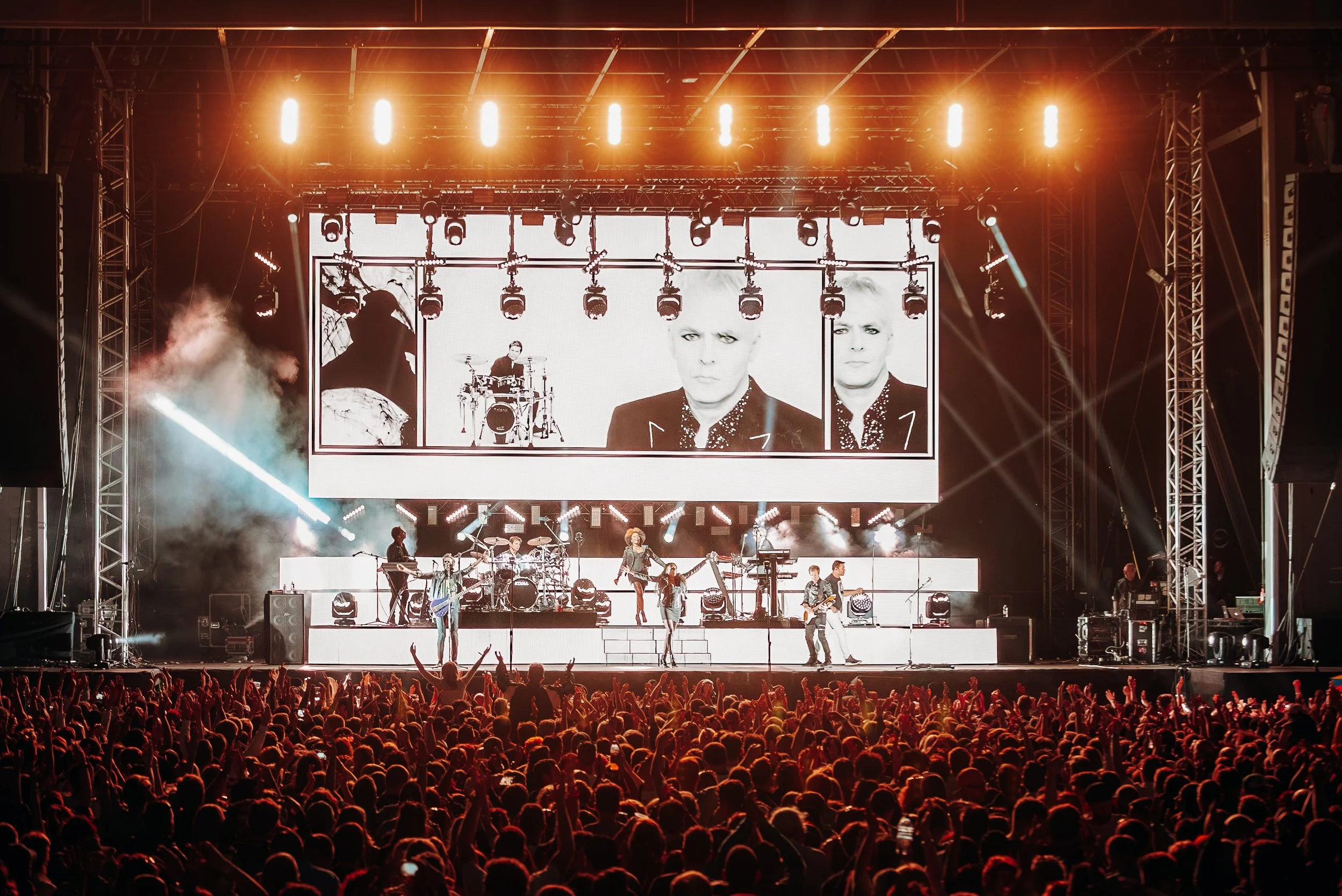 A wide-angle view of Duran Duran performing on the illuminated main stage to a packed crowd at the Common People festival on Southampton Common, Hampshire. Large-scale music festival and iconic headline act concert photography by Will Bailey.