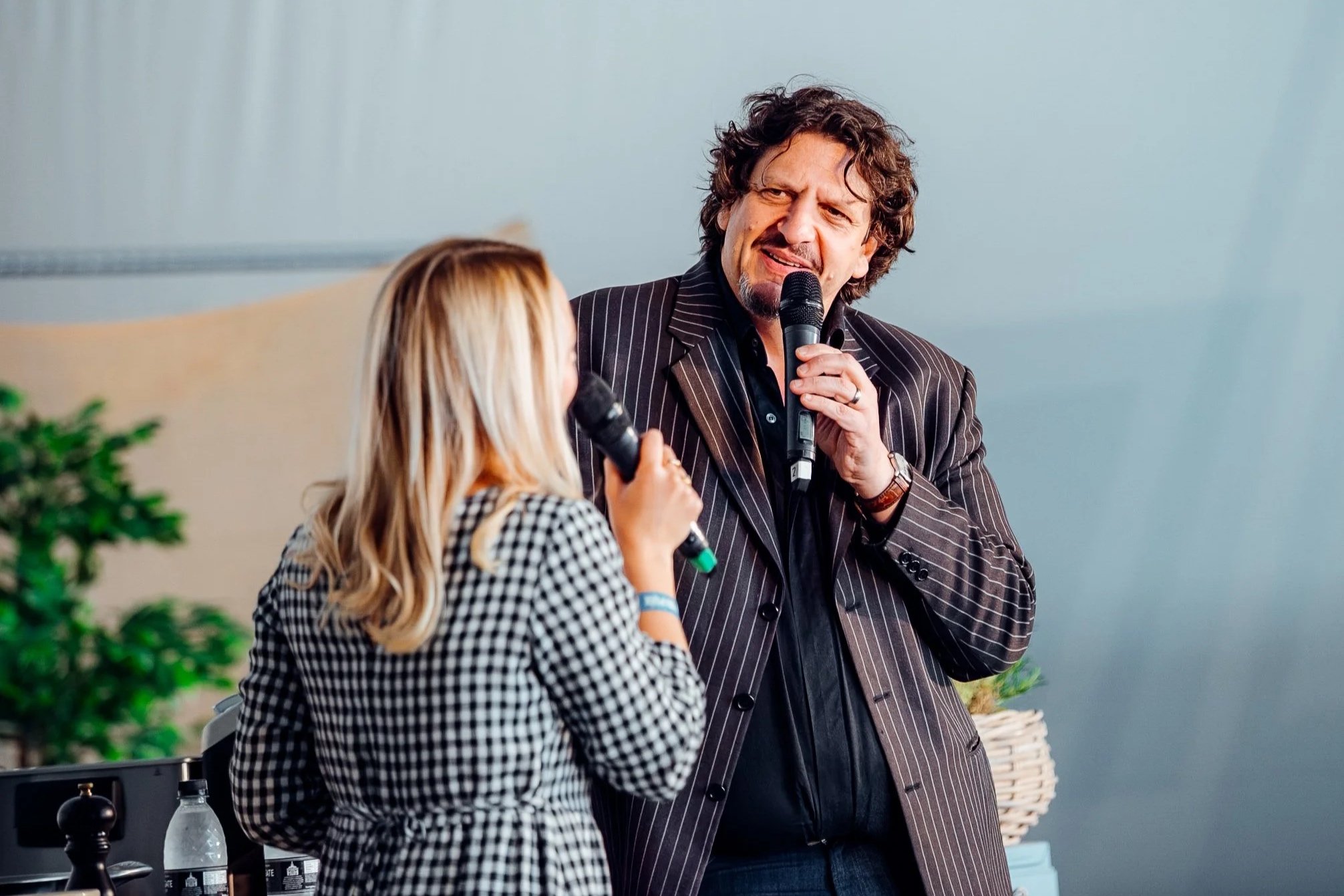 Celebrity food critic, author, and broadcaster Jay Rayner speaking live on stage during an interactive theater presentation at a premium summer cultural festival. High-profile entertainment and editorial event photography by Will Bailey.